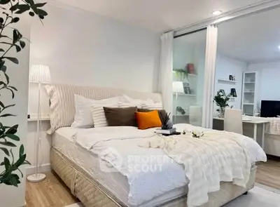 Modern bedroom with cozy decor and adjacent study area, perfect for urban living.