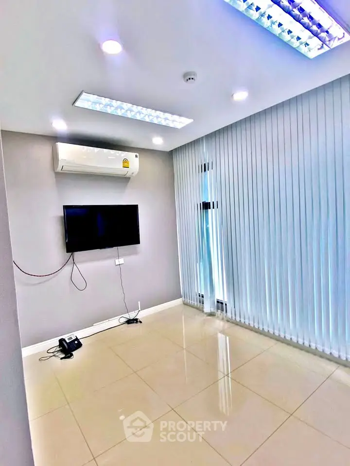 Modern living room with sleek air conditioning and floor-to-ceiling blinds, perfect for a minimalist lifestyle.