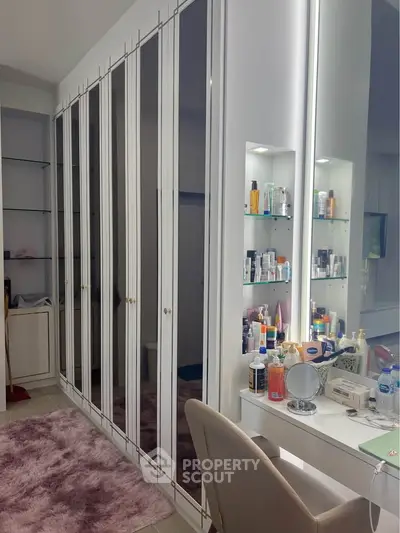 Elegant bedroom with mirrored wardrobe and stylish vanity area