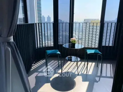 Stunning high-rise balcony with panoramic city views and modern seating area.