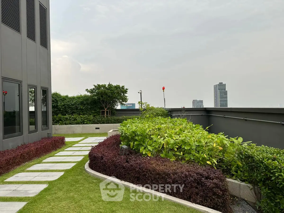 Stunning rooftop garden with lush greenery and city skyline view.