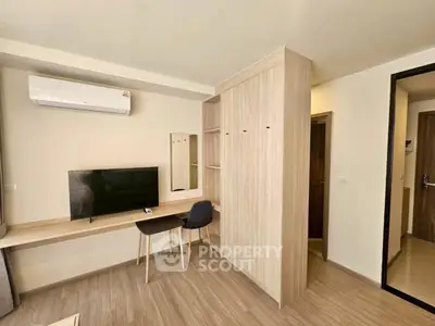 Modern study room with sleek wooden furniture and wall-mounted TV