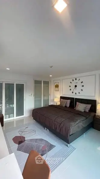 Spacious modern bedroom with stylish decor and large bed in a contemporary apartment.