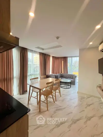 Spacious modern living room with elegant dining area and natural light