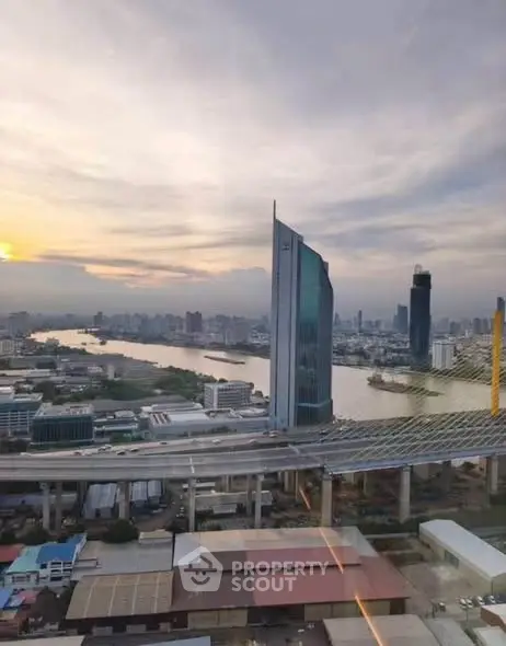 Stunning cityscape view with modern skyscrapers and river at sunset, perfect for urban living enthusiasts.