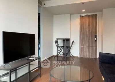 Modern living room with sleek TV setup and stylish furniture in a contemporary apartment.