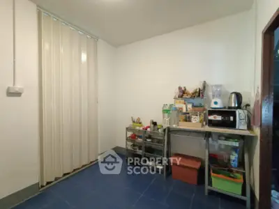 Cozy kitchen with blue tile floor and compact storage solutions