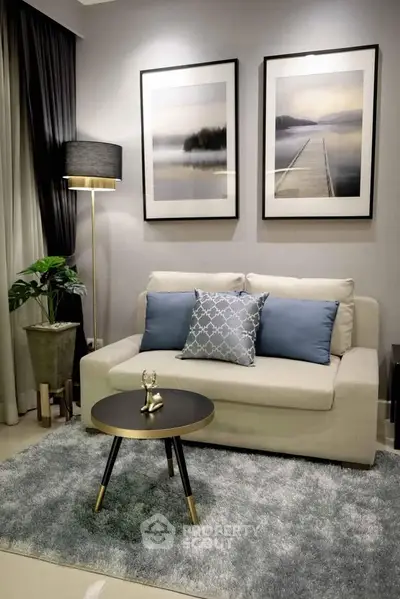 Stylish living room with modern decor, cozy sofa, and elegant artwork.