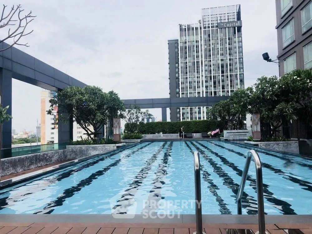Luxurious rooftop pool with stunning city views in modern high-rise building.
