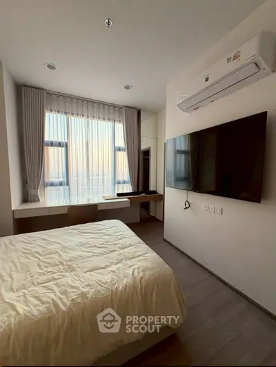 Modern bedroom with large window, wall-mounted TV, and air conditioning unit.