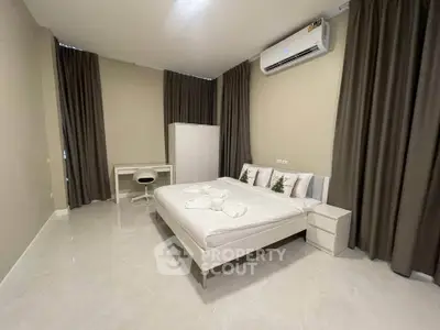 Spacious modern bedroom with minimalist decor and air conditioning