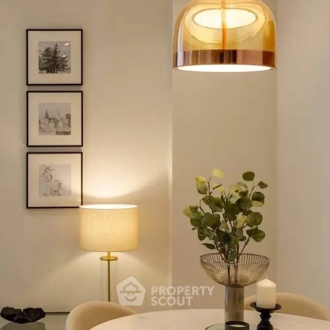 Elegant dining area with modern lighting and stylish decor, perfect for contemporary living.