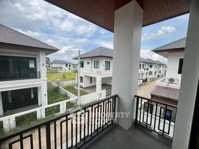Charming balcony view of modern residential neighborhood with clear skies and elegant architecture.