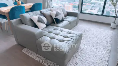 Stylish living room with modern leather sofa and city view window