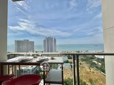 Stunning ocean view from high-rise balcony with elegant dining setup.