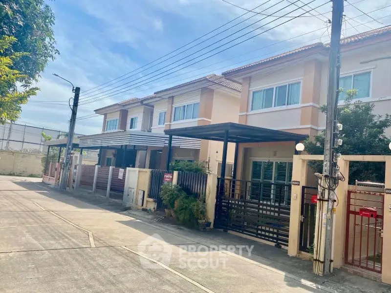 Charming suburban townhouse with gated entrance and modern design, perfect for family living.