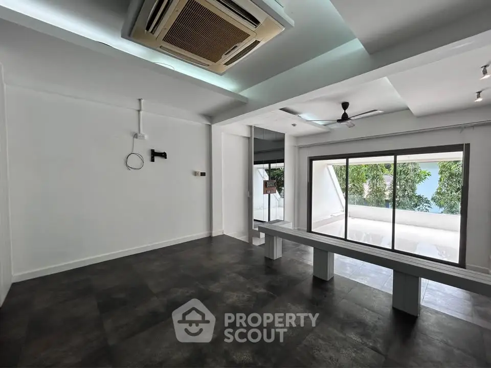 Spacious modern living room with large windows and sleek flooring