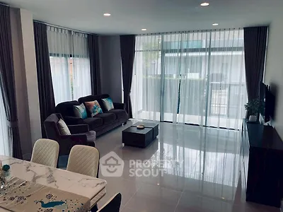 Spacious modern living room with large windows and elegant decor