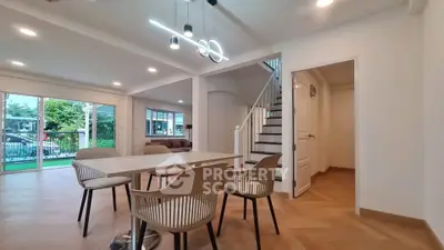 Spacious modern dining area with elegant lighting and garden view