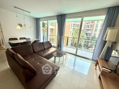 Spacious living room with modern furniture and balcony view in luxury apartment