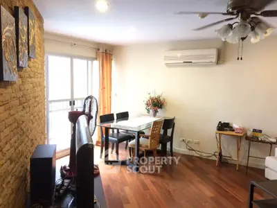 Spacious living room with wooden flooring, air conditioning, and modern decor in a stylish apartment.
