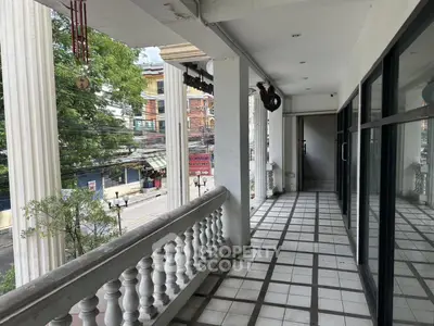 Spacious balcony with classic railing and city view, perfect for relaxation and entertainment.
