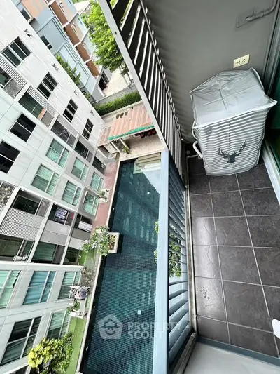 Modern balcony view overlooking a stylish pool in a contemporary apartment complex.