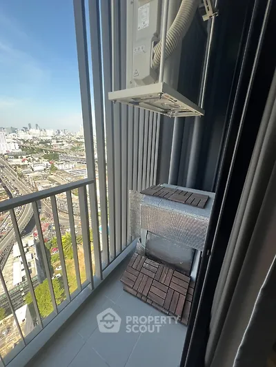 High-rise balcony with city view and air conditioning unit