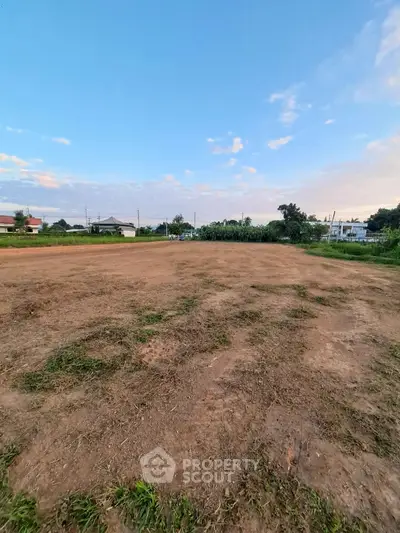 Expansive vacant land with clear skies, perfect for development opportunities.