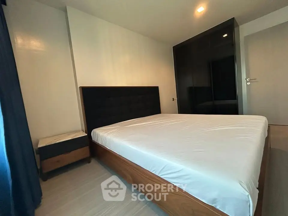 Spacious bedroom with modern furnishings and ample natural light