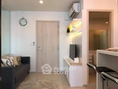 Modern living room with stylish decor and open layout, featuring a cozy sofa and wall-mounted TV.