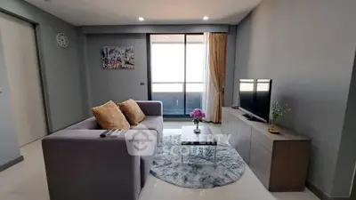 Modern living room with cozy sofa, stylish decor, and balcony view in a contemporary apartment.