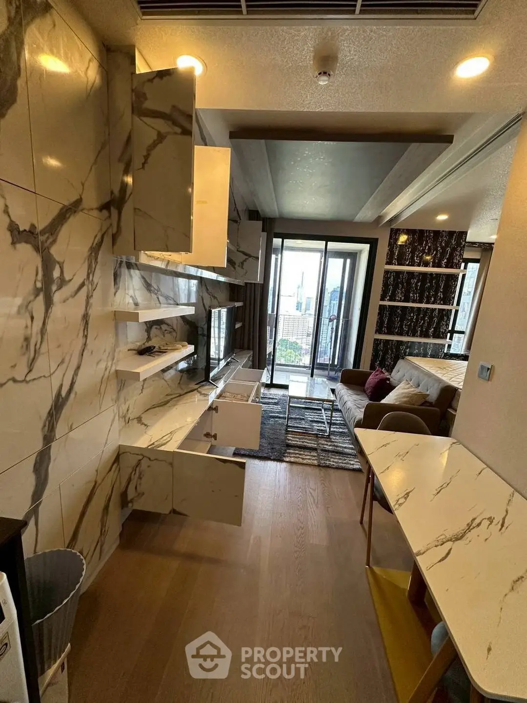 Modern living room with marble accents and open balcony view