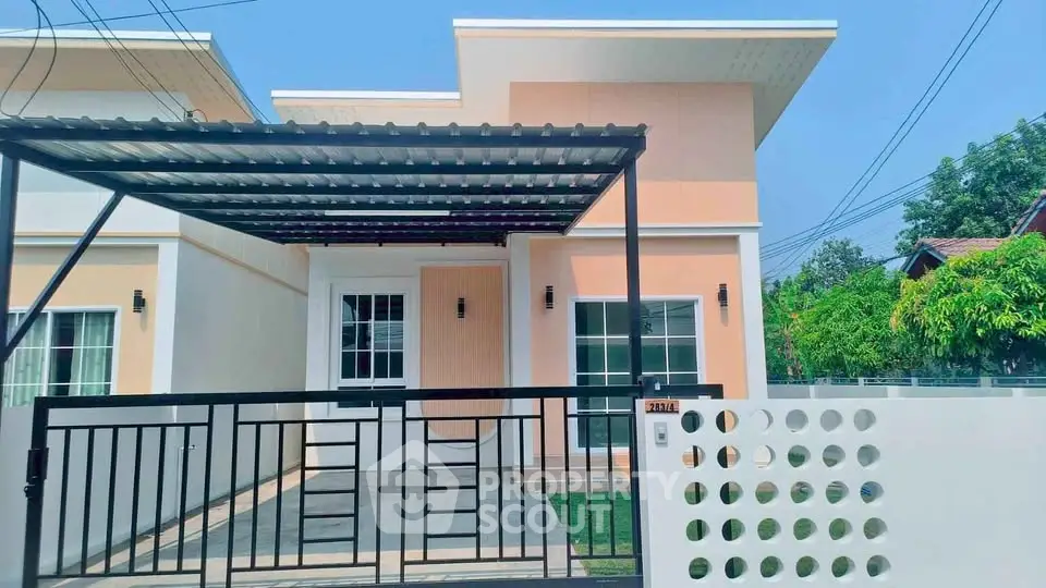 Modern single-story house with gated entrance and carport in a serene neighborhood.