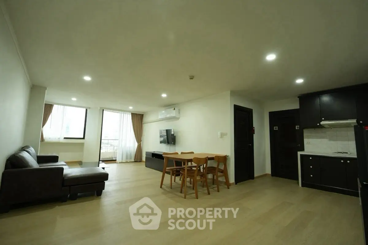 Spacious modern living room with open kitchen and natural light