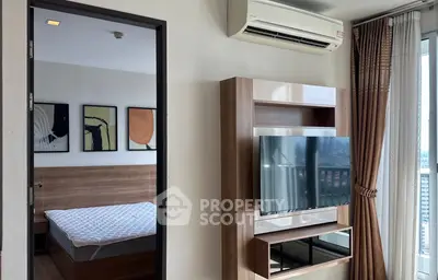 Modern bedroom with wall-mounted TV and air conditioning, featuring stylish decor and large window view.