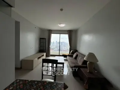 Spacious living room with city view, featuring modern furniture and large window for natural light.