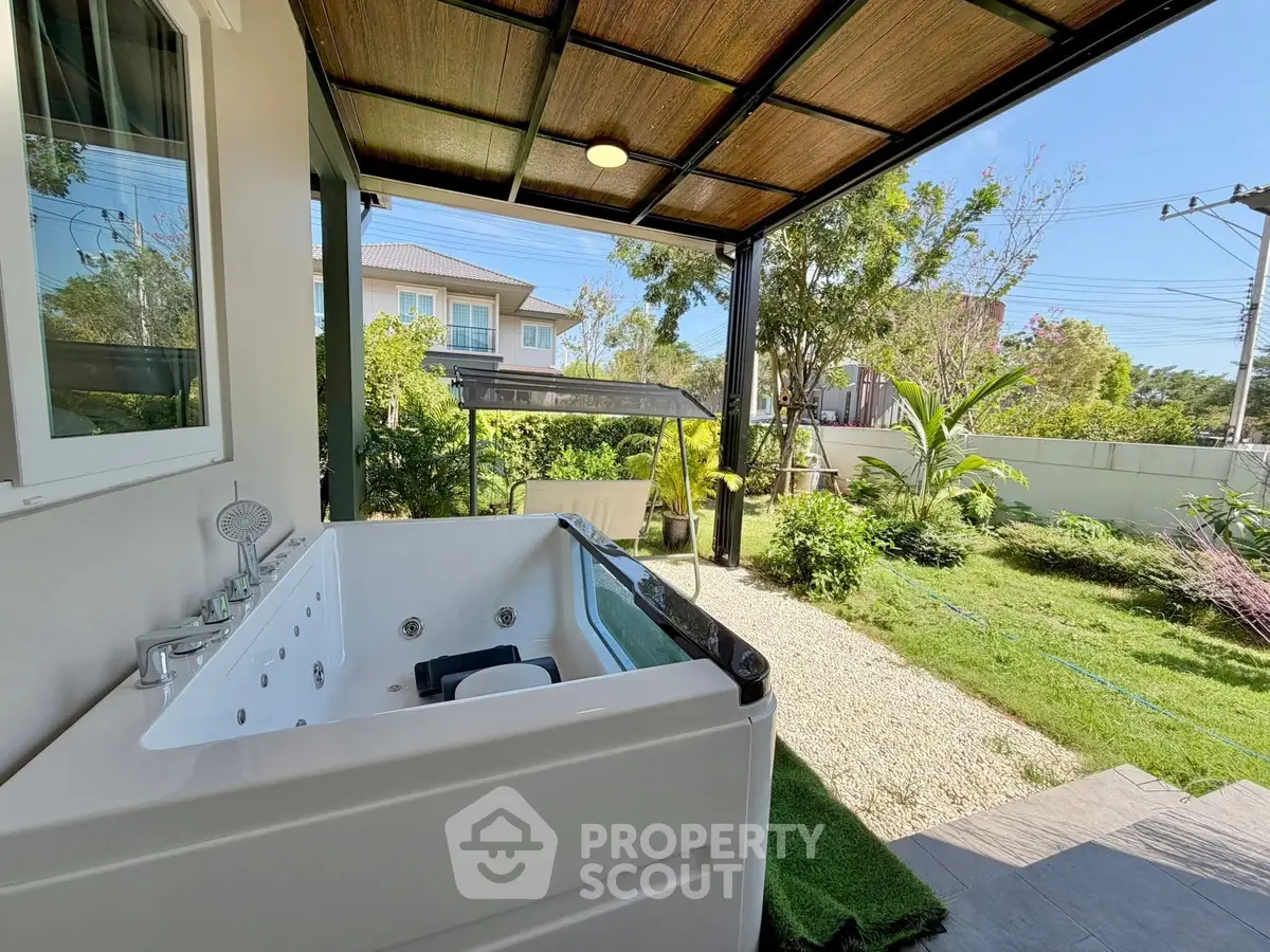 Charming garden view with outdoor jacuzzi and lush greenery