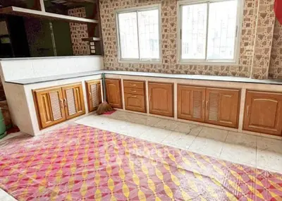 Spacious kitchen with wooden cabinets and tiled backsplash, ideal for culinary enthusiasts.