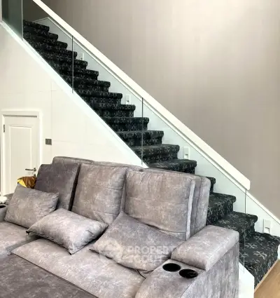 Modern living room with stylish staircase and cozy seating area