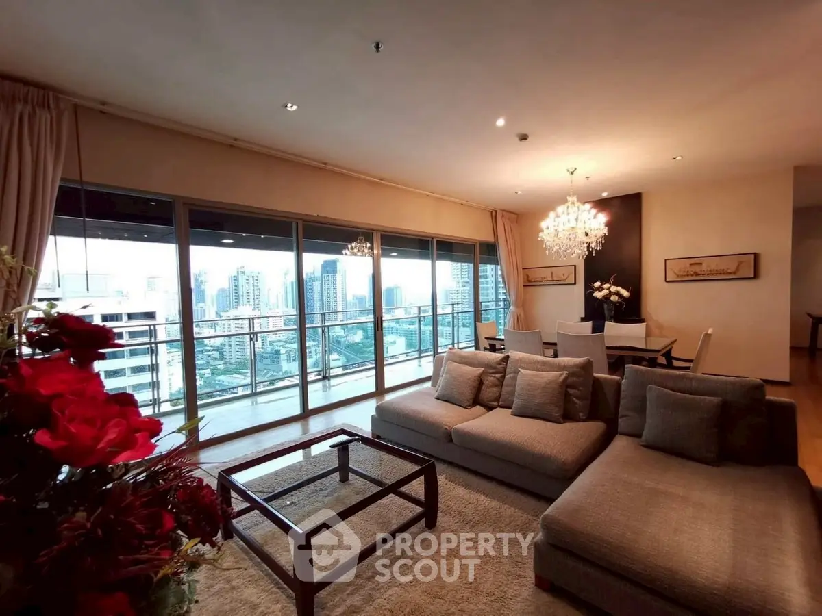 Luxurious living room with city view, elegant chandelier, and spacious seating area in modern apartment.