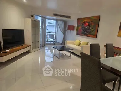 Spacious modern living room with sleek furniture and vibrant artwork, perfect for stylish urban living.