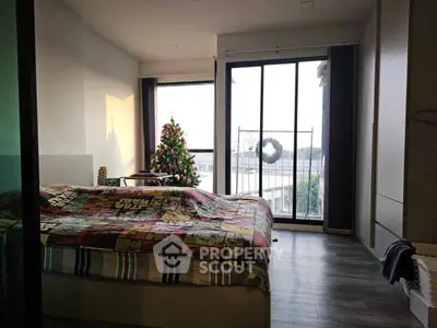 Cozy bedroom with festive decor and balcony view, perfect for holiday relaxation.
