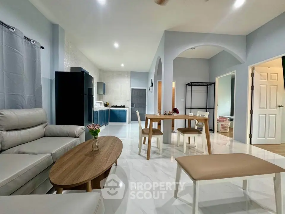 Spacious modern living room with open kitchen and stylish furniture