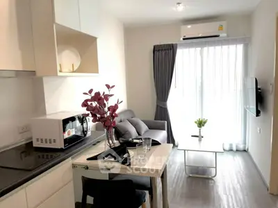Modern living room with sleek kitchen, cozy sofa, and natural light from large window.