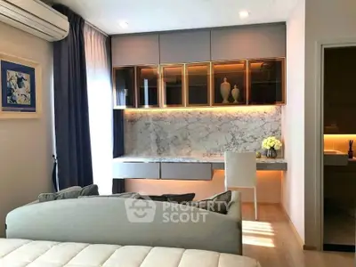 Modern living room with elegant decor and built-in storage, featuring a cozy seating area and stylish lighting.