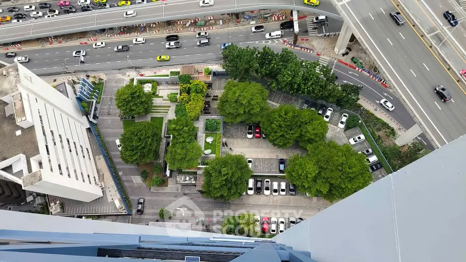 Stunning aerial view of urban landscape with lush greenery and modern infrastructure, showcasing vibrant city life.