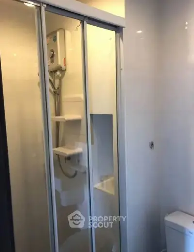 Modern bathroom with sleek shower enclosure and water heater