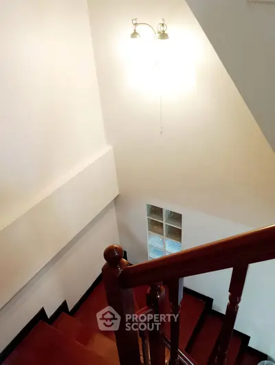 Elegant wooden staircase with warm lighting in a modern home