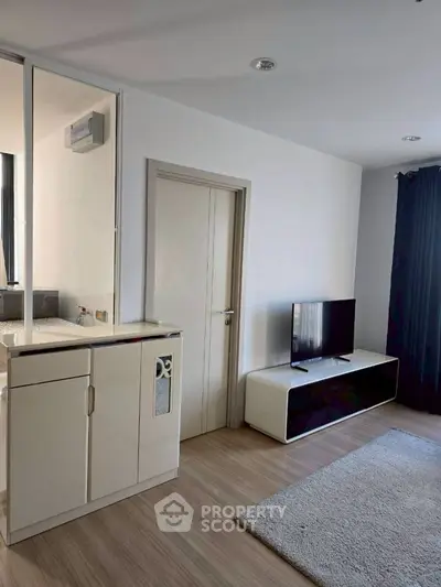 Modern living room with sleek TV stand and cozy carpet